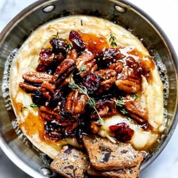 Baked Brie with Cranberries, Pecans, Fig Jam and Thyme | foodiecrush.com #recipes #baked #brie #appetizer #cheese #holidays