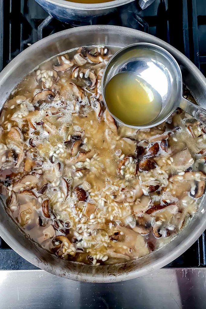 Ladle broth in mushroom risotto | foodiecrush.com