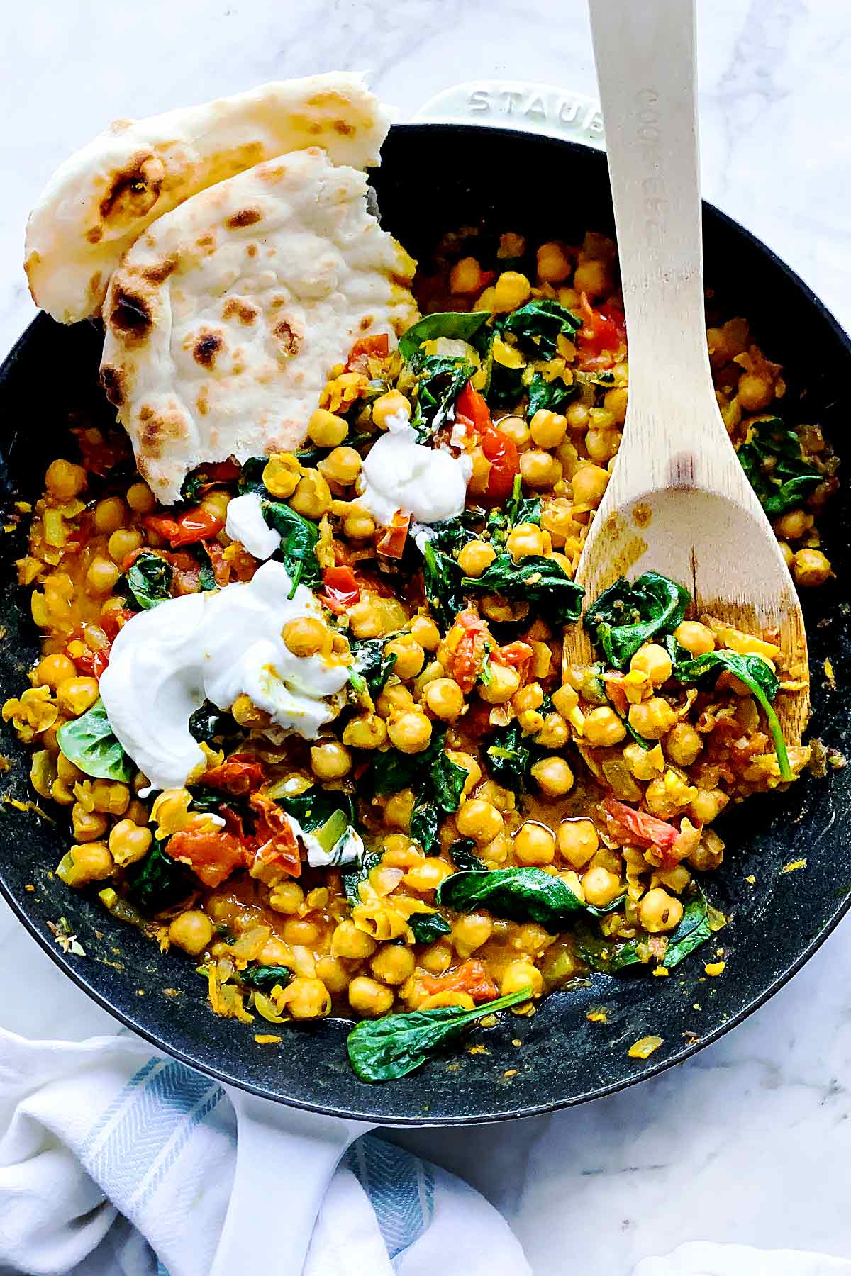 Chana Masala in skillet with yogurt foodiecrush.com