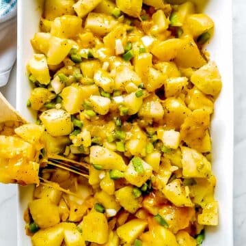 Cheesy Potatoes with bell pepper and onions in pan foodiecrush.com