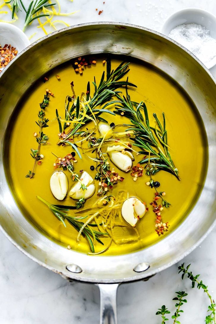 Steeped herbs and garlic in olive oil foodiecrush.com