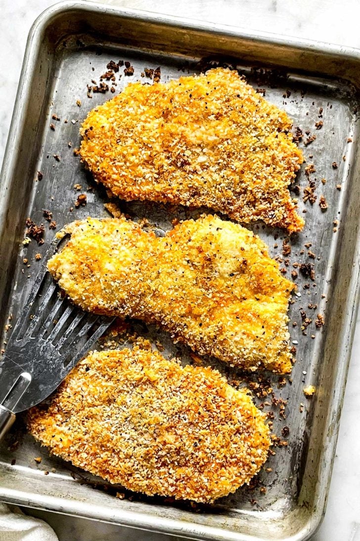 Crispy Baked Buffalo Chicken Breasts 6 Baked Buffalo Chicken Breasts on baking sheet foodiecrush.com