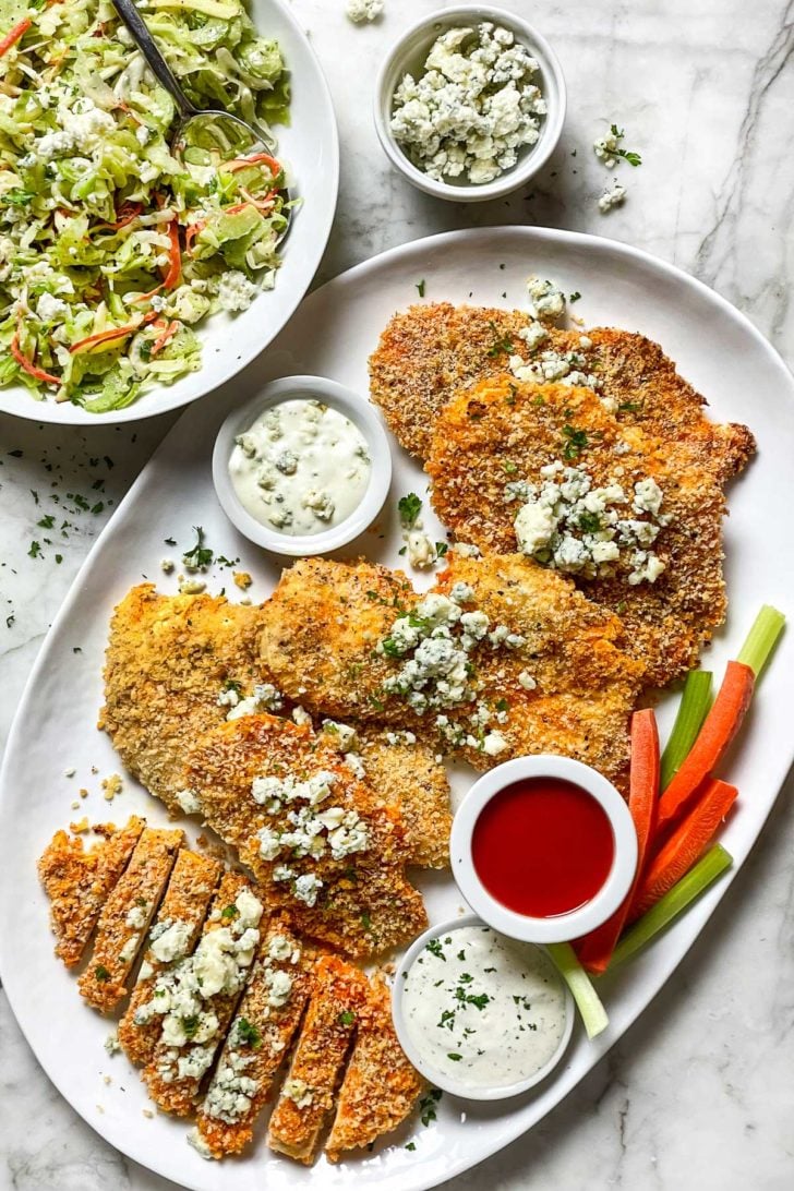 Crispy Baked Buffalo Chicken Breasts 8 Baked Buffalo Chicken Breasts on plate with Celery Slaw foodiecrush.com