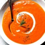Tomato and Roasted Red Pepper Soup in bowl with spoon foodiecrush.com