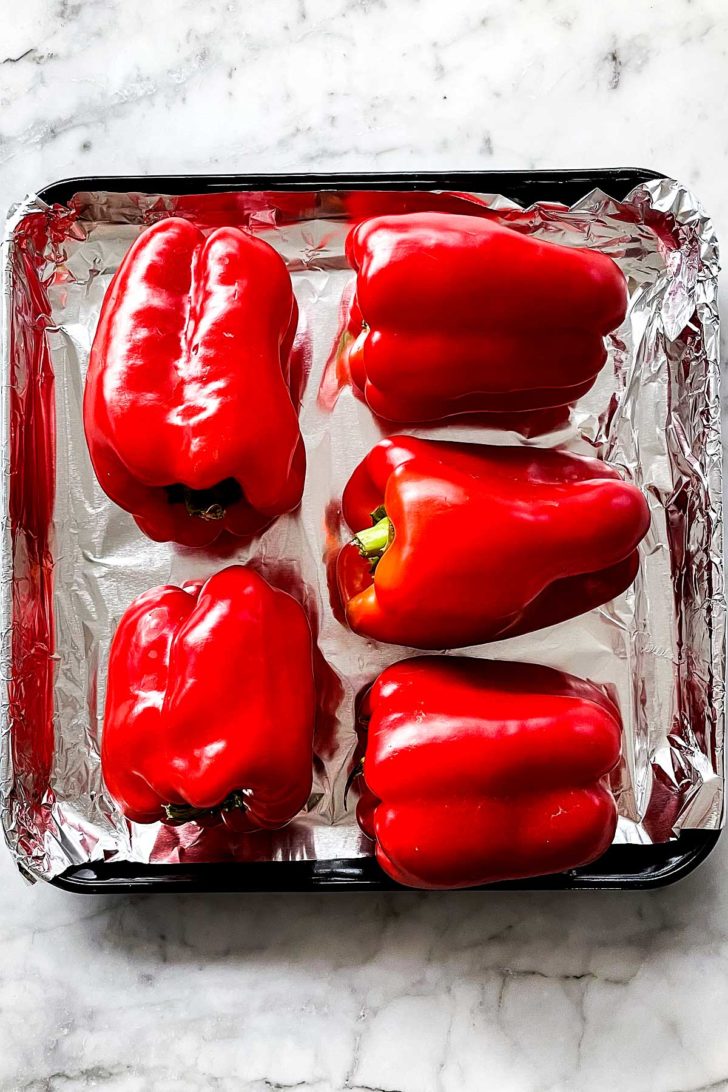 Red bell peppers on baking sheet foodiecrush.com