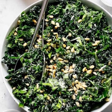 Kale Salad with Parmesan and Pine Nuts in bowl foodiecrush.com