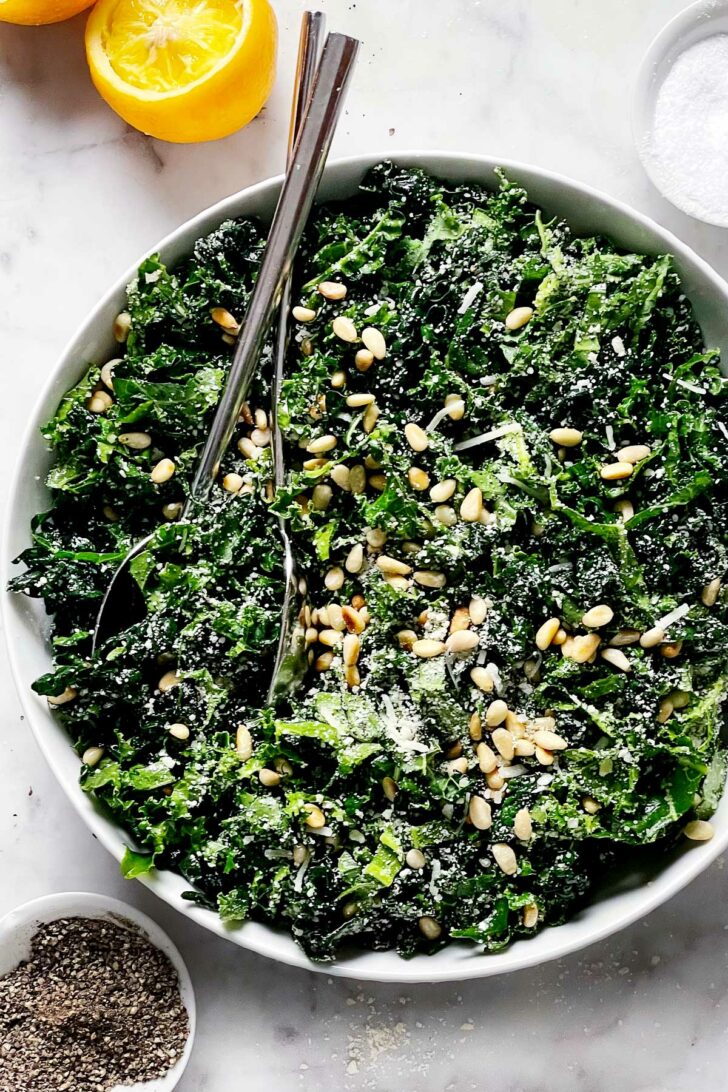 Kale Salad with Parmesan and Pine Nuts in bowl foodiecrush.com