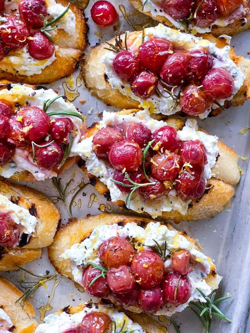 Roasted Grape and Whipped Goat Cheese Crostini on baking sheet foodiecrush.com