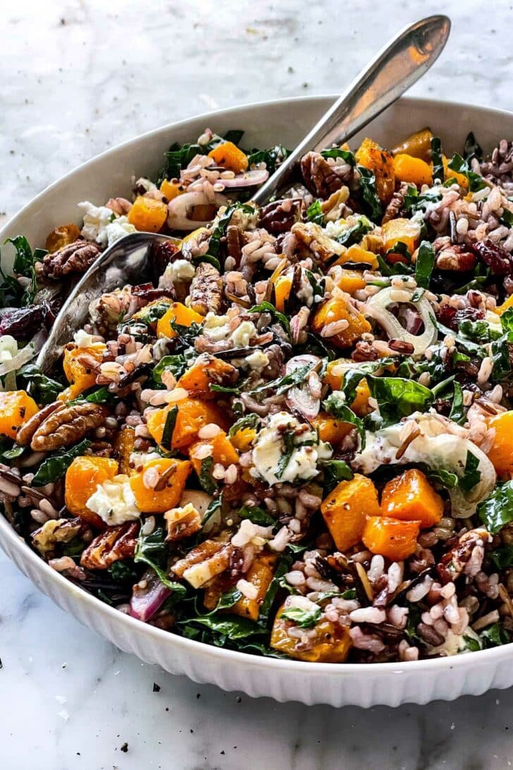 Kale Salad with Wild Rice, Butternut Squash, and Goat Cheese in bowl foodiecrush.com