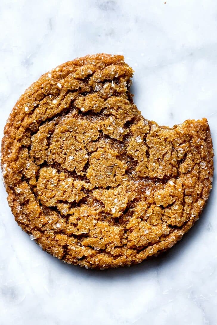Chewy Ginger Cookie with bite out of it foodiecrush.com