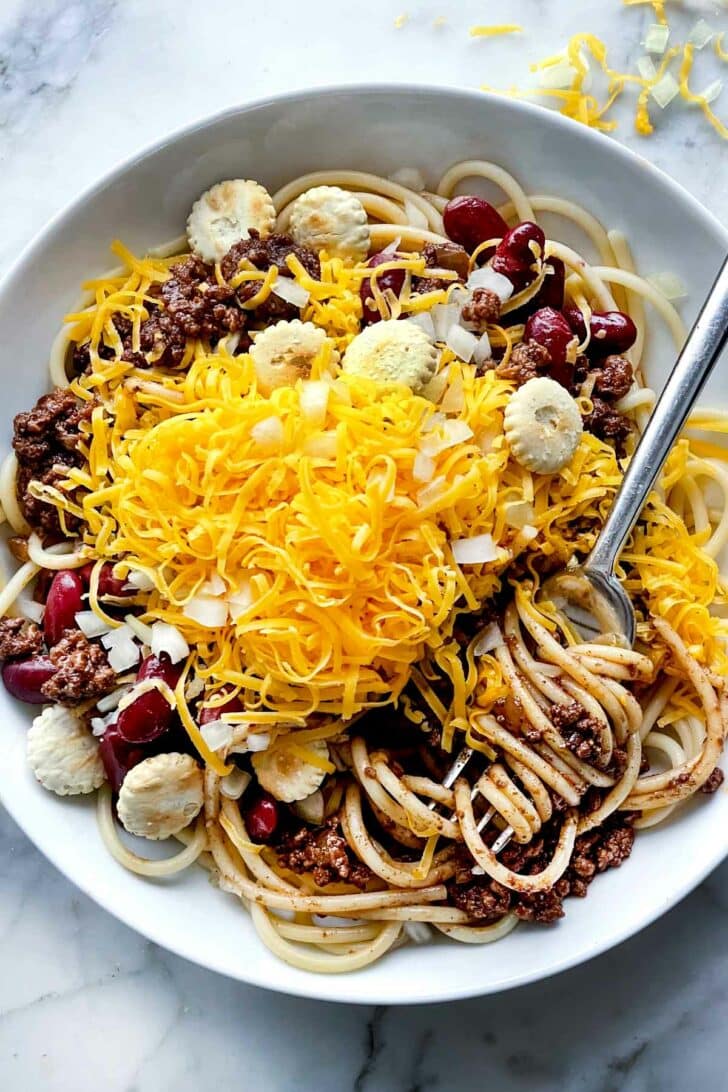 Cincinnati Chili with spaghetti in bowl with fixings foodiecrush.com