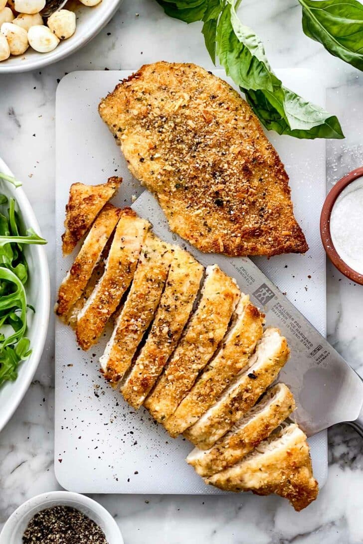 Parmesan Crusted Chicken on cutting board foodiecrush.com
