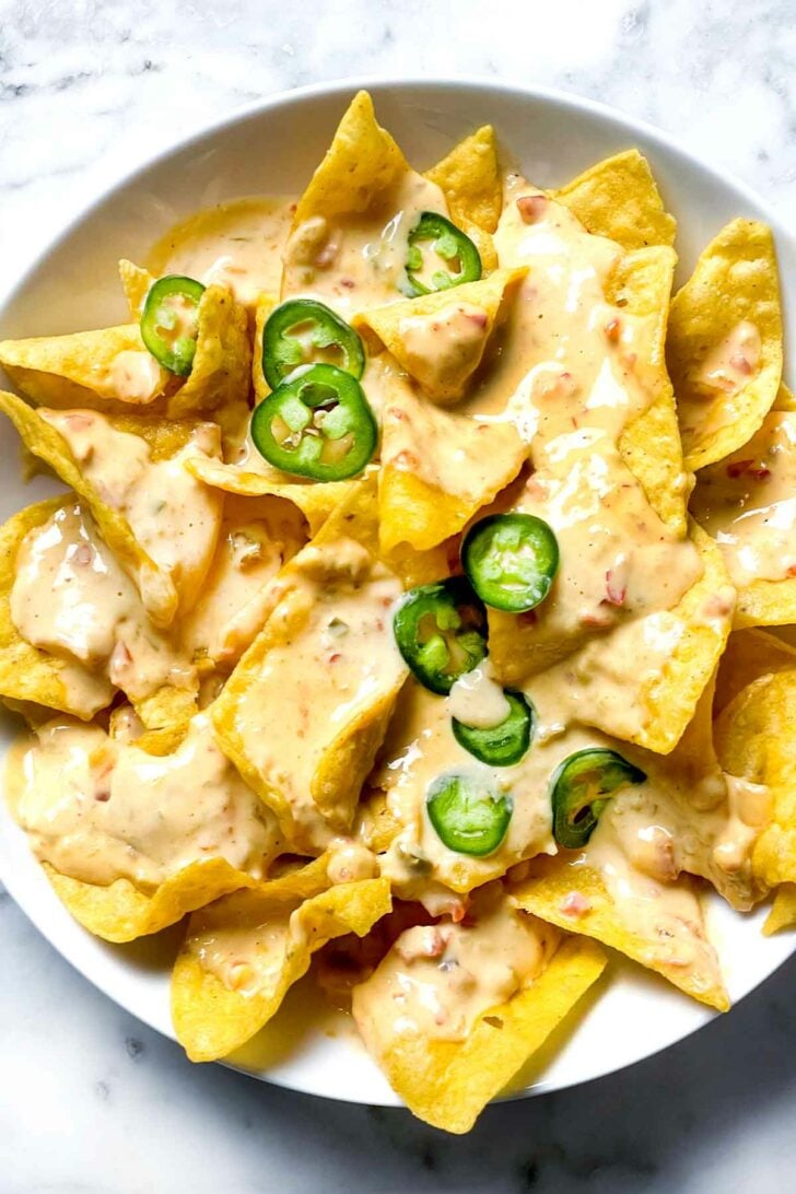 Queso dip and chips with jalapenos foodiecrush.com
