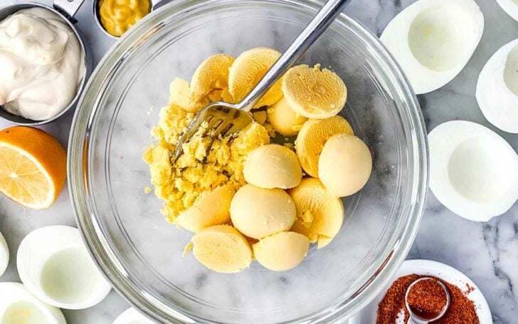 Egg yolks in bowl for deviled eggs foodiecrush.com