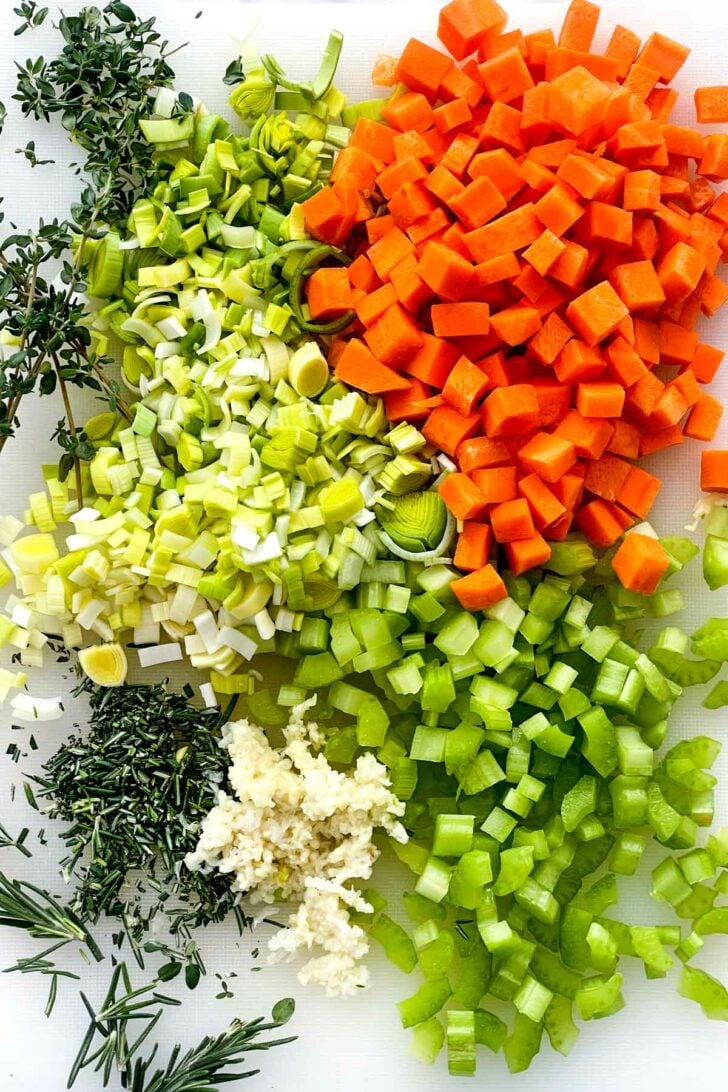 Carrots celery leeks garlic on cutting board foodiecrush.com