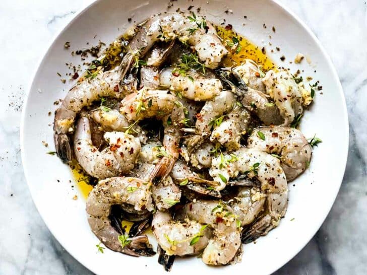 Shrimp in bowl with seasonings and olive oil and garlic foodiecrush.com