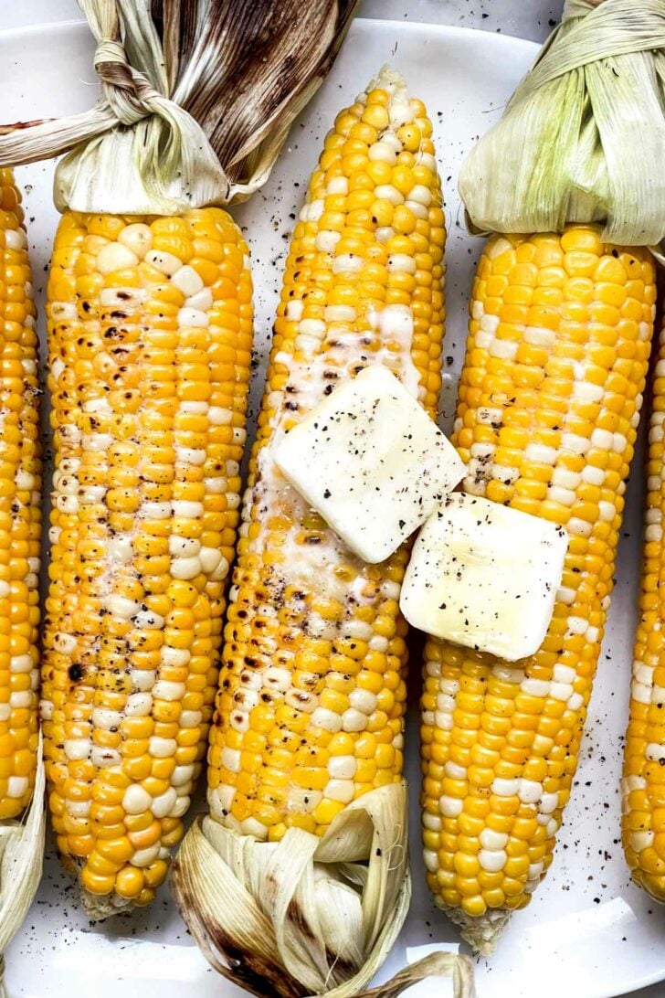 Grilled Corn on the Cob with butter on platter foodiecrush.com