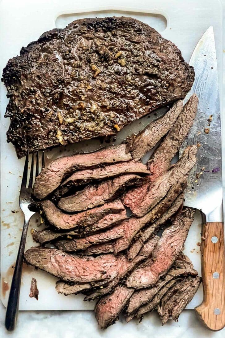 Grilled Flank Steak sliced on cutting board foodiecrush.com