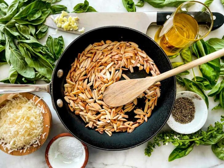 Toasted almonds in skillet with pesto ingredients foodiecrush.com
