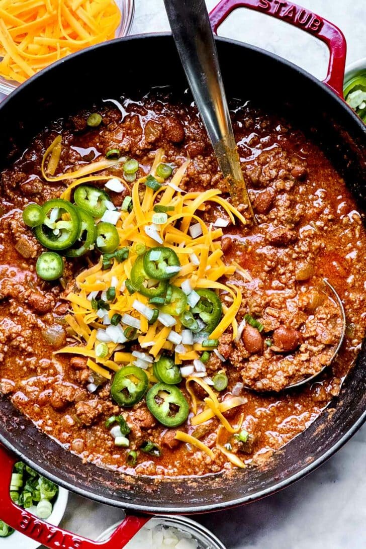 The Best Beef Chili Recipe with crushed  beef and beans and food  and jalapenos successful  stockpot with ladle foodiecrush.com