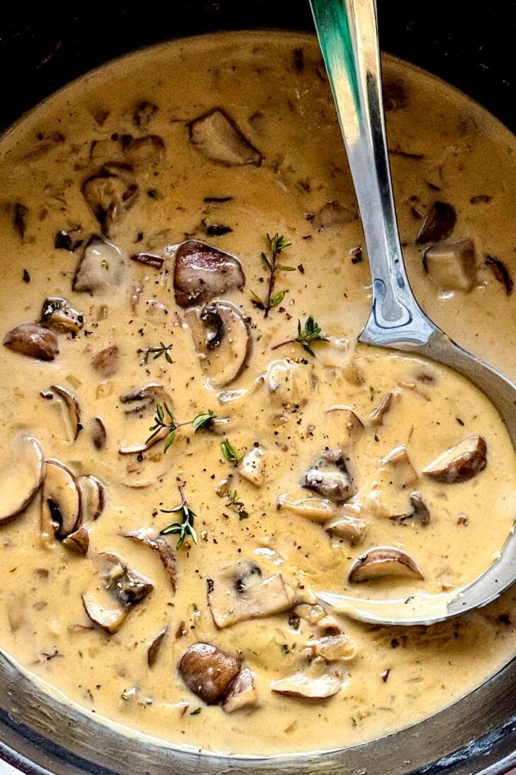 Cream of Mushroom Soup in pot with ladle foodiecrush.com