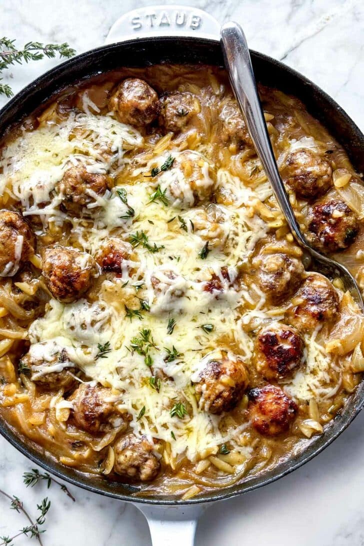 French Onion Meatballs with Orzo in skillet with gruyere cheese foodiecrush.com