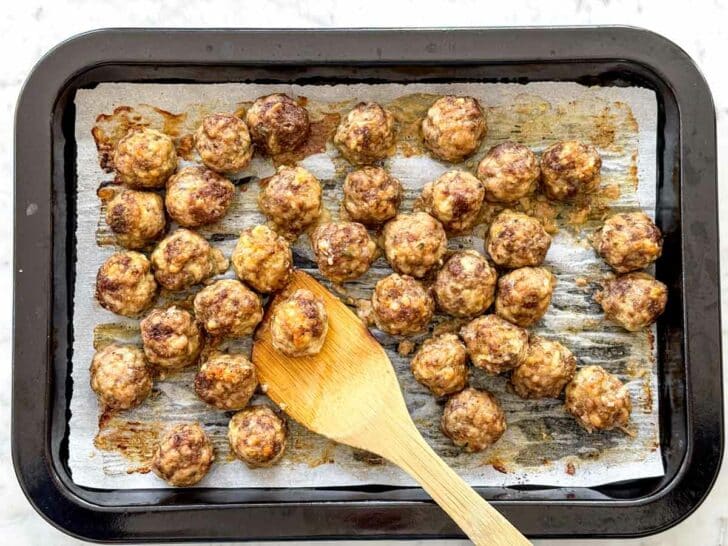 French Onion Meatballs with Orzo meatballs on a baking sheet foodiecrush.com