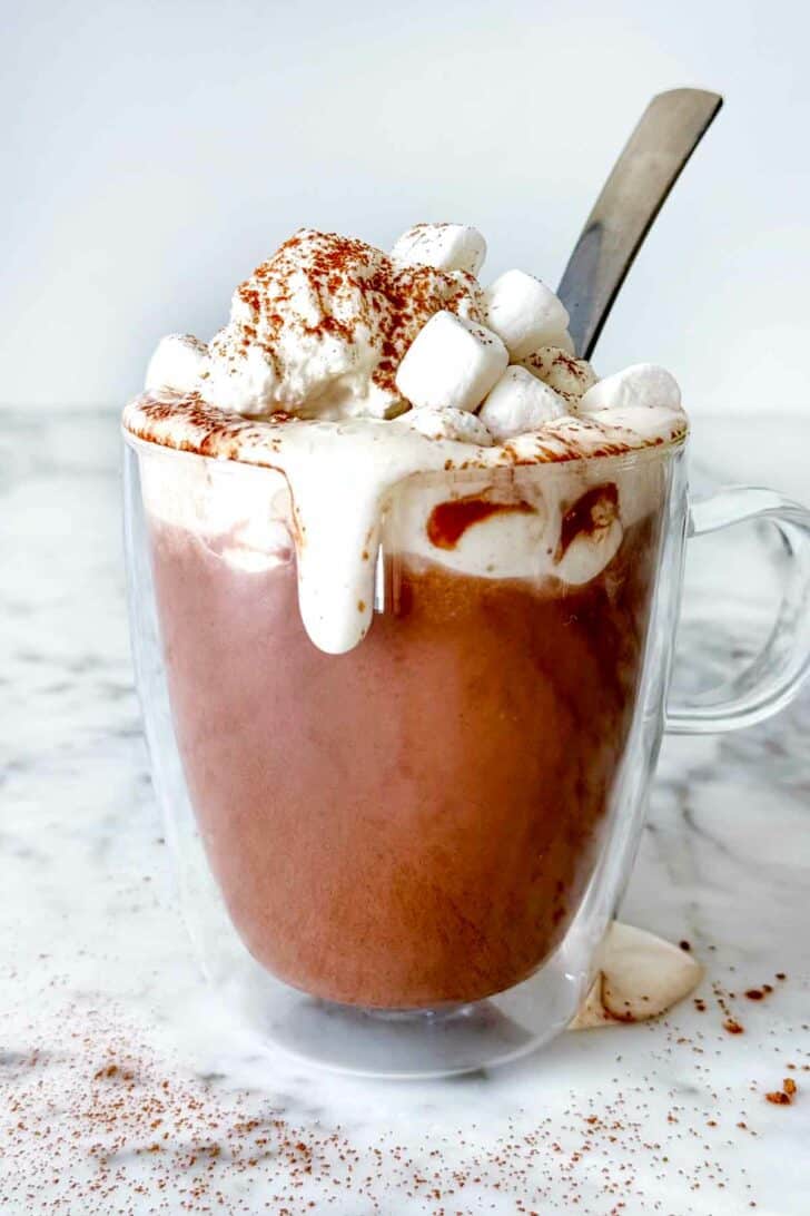 Hot Chocolate with whipped cream and marshmallows foodiecrush.com #recipe #hotchocolate
