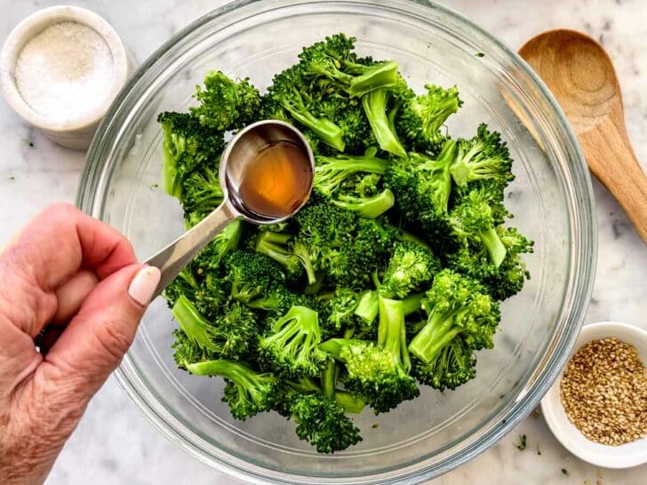 Broccoli in bowl with sesame oil and seeds foodiecrush.com