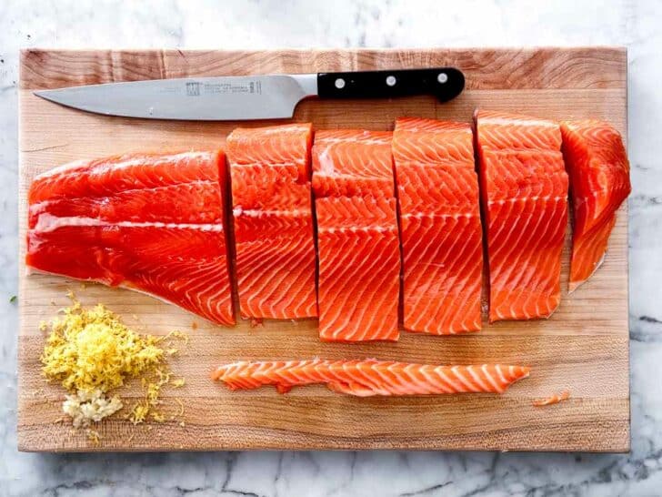 Salmon filets with knife on cutting board foodiecrush.com