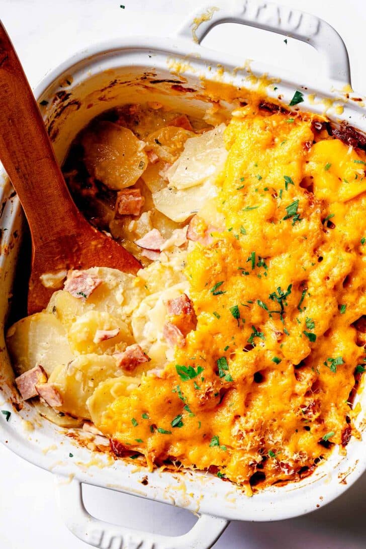 Ham and Potatoes au gratin in baking dish with spoon