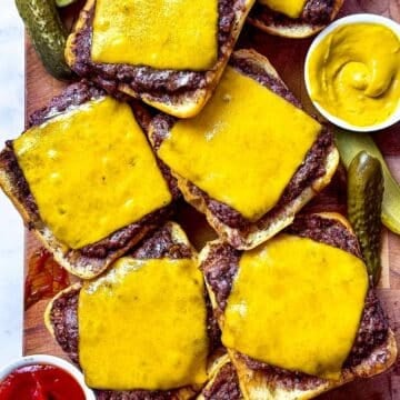 Baked hamburgers with cheese on cutting board