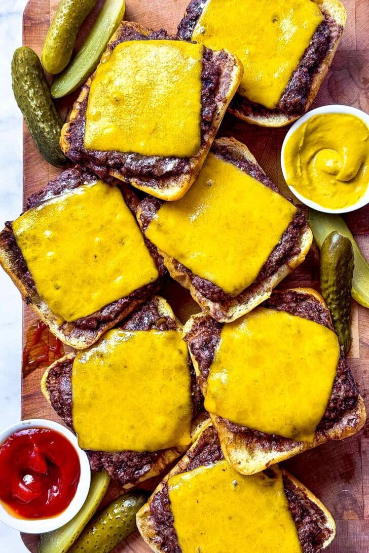 Baked hamburgers with cheese on cutting board