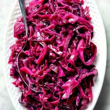 Sweet and Sour Red Cabbage in serving dish with spoon