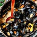 Steamed Mussels in skillet with spoon