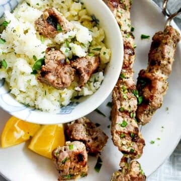 Pork Souvlaki with Lemon Rice on plate and in bowl