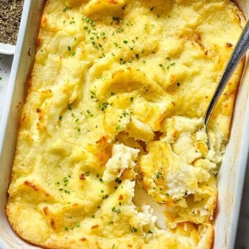 Mashed Potato Casserole in baking dish with spoon