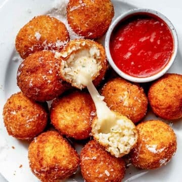 Arancini with melted mozzarella cheese center and marinara sauce for dipping