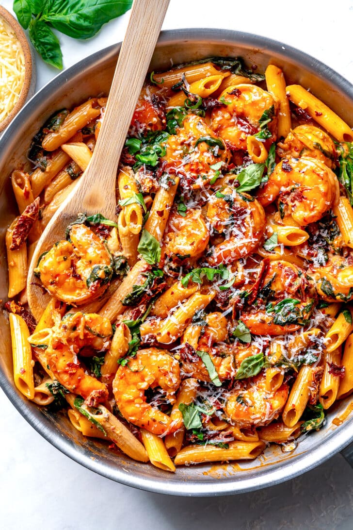 Marry Me Shrimp Pasta in skillet with serving spoon