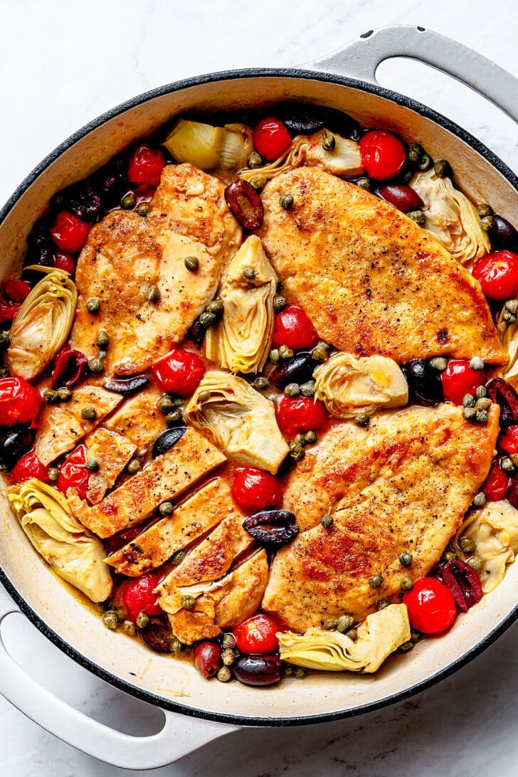 One-Pot Mediterranean Chicken in skillet with spoon