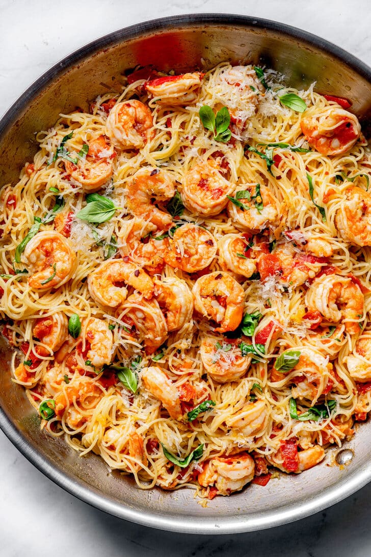 Shrimp Scampi Pasta with tomatoes with angel hair pasta in skillet