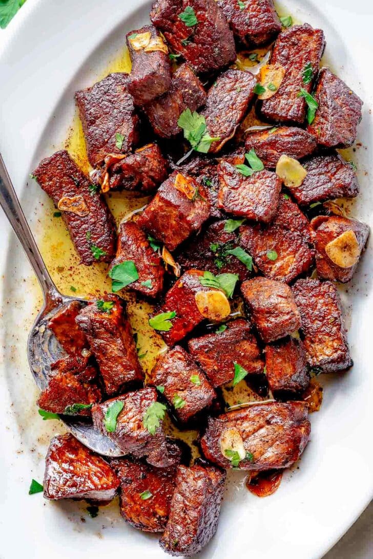 Steak Bites on platter with spoon
