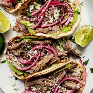 Salsa Verde Pork Tacos on platter with pickled onion