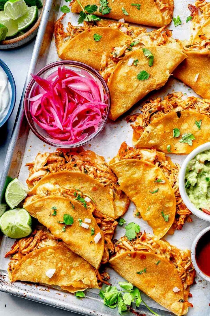 Crispy chicken tacos on baking sheets