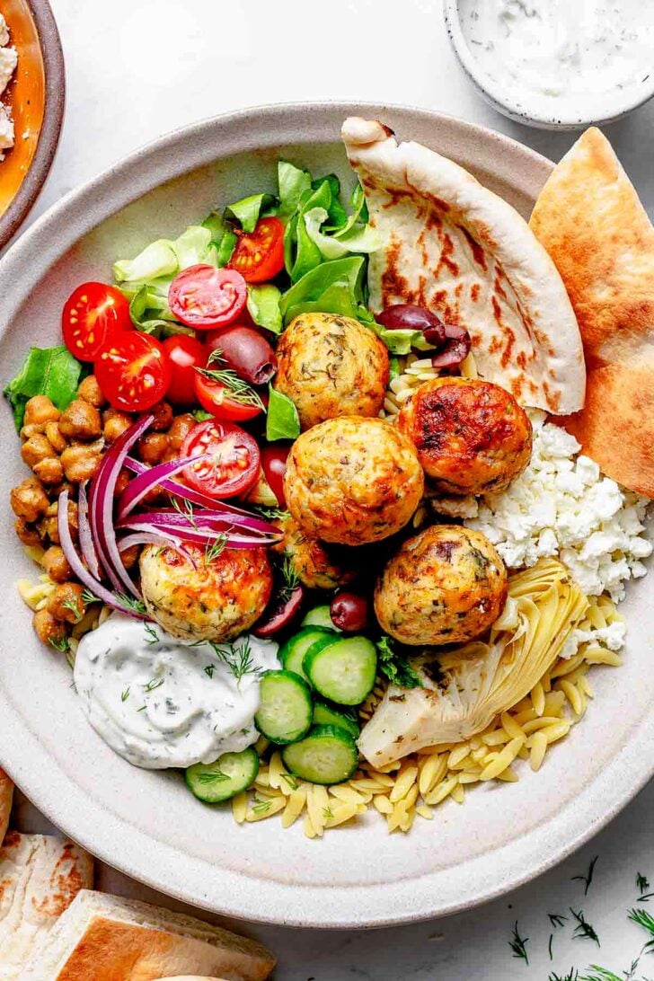 Mediterranean Chicken Meatball Bowls with pita bread and orzo