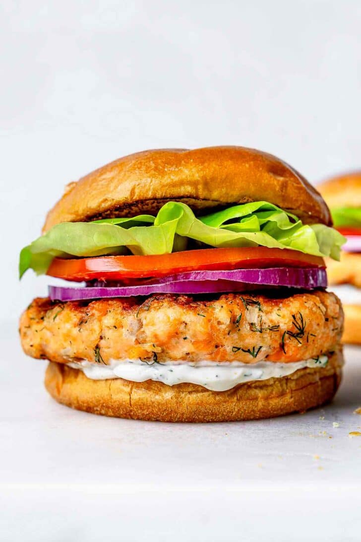 Salmon Burger on bun with cucumber dill sauce
