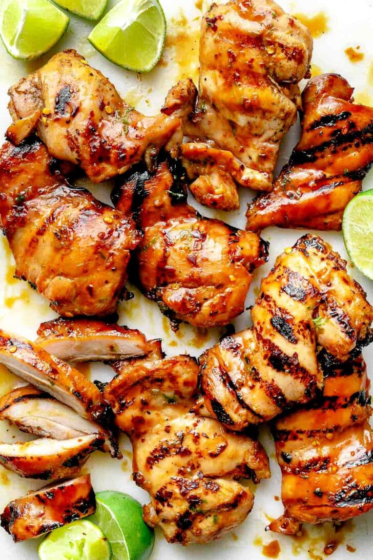 Grilled Honey Lime Chicken on cutting board with limes