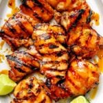 Grilled Honey Lime Chicken on platter with limes
