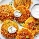 Corn Fritters recipe on platter with sour cream
